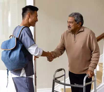 senior man greeting caregiver